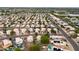 Wide aerial view of a residential area featuring single-Gathering homes, community pools, and green landscaping at 15715 W Cottonwood St, Surprise, AZ 85374