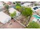 Aerial shot of a backyard featuring a potential landscaping project, mature trees, and a refreshing pool at 15715 W Cottonwood St, Surprise, AZ 85374