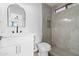 Updated bathroom features a modern vanity, large mirror and a tiled walk-in shower at 15715 W Cottonwood St, Surprise, AZ 85374
