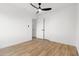 Light filled bedroom has light wood floors, white walls, and access to the rest of the home at 15715 W Cottonwood St, Surprise, AZ 85374