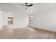 A simple, clean bedroom with wood-look tile, a window, and a ceiling fan at 15715 W Cottonwood St, Surprise, AZ 85374