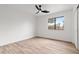 Bright bedroom features wood floors, a modern ceiling fan and a light-filled window at 15715 W Cottonwood St, Surprise, AZ 85374