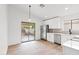 Eat-in kitchen with stainless steel appliances, white cabinets and a sliding glass door at 15715 W Cottonwood St, Surprise, AZ 85374