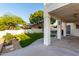 Covered patio area overlooks the manicured backyard with mature trees and an expansive lawn at 1625 E Monte Cristo Ave, Phoenix, AZ 85022