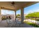 Covered balcony seating with view of neighborhood homes, desert landscape and bright blue sky at 1625 E Monte Cristo Ave, Phoenix, AZ 85022
