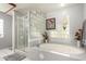 Bathroom with tub, glass block detail and enclosed shower at 1625 E Monte Cristo Ave, Phoenix, AZ 85022