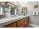 Bathroom vanity with double sinks, tile countertop, and wood cabinets at 1625 E Monte Cristo Ave, Phoenix, AZ 85022