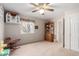 Light-filled bedroom features a ceiling fan, carpet, and a charming dollhouse detail at 1625 E Monte Cristo Ave, Phoenix, AZ 85022