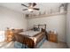 Comfortable bedroom with ceiling fan, carpet, and shelf for decorations at 1625 E Monte Cristo Ave, Phoenix, AZ 85022