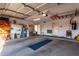 Spacious garage with ample storage shelves, utility sink, and access to the interior of the house at 1625 E Monte Cristo Ave, Phoenix, AZ 85022
