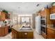 Bright kitchen features granite countertops, an island with cooktop, and stainless steel double ovens at 1625 E Monte Cristo Ave, Phoenix, AZ 85022