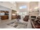 Cozy living room with soaring ceilings, large windows, a gas fireplace, and breakfast bar at 1625 E Monte Cristo Ave, Phoenix, AZ 85022