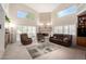 Cozy living room with soaring ceilings, large windows, and a gas fireplace at 1625 E Monte Cristo Ave, Phoenix, AZ 85022