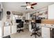 Spacious office area features built-in desks, shelving, and a ceiling fan for a functional workspace at 1625 E Monte Cristo Ave, Phoenix, AZ 85022