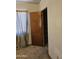 Bedroom with worn carpet and open door to another room at 1630 E Catalina Dr, Phoenix, AZ 85016