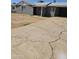 Cracked concrete driveway leading to the carport and front of the gray exterior house at 1630 E Catalina Dr, Phoenix, AZ 85016