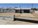 Charming gray home featuring a covered carport, black iron gate, and a low-maintenance yard at 1630 E Catalina Dr, Phoenix, AZ 85016