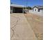 Long concrete driveway leading up to the carport, and a dry, low-maintenance front yard at 1630 E Catalina Dr, Phoenix, AZ 85016
