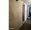 Hallway leading to other rooms with worn walls and a view into another room at 1630 E Catalina Dr, Phoenix, AZ 85016