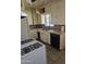 Kitchen with ample cabinetry, black appliances, and a window above the sink for natural light at 1630 E Catalina Dr, Phoenix, AZ 85016
