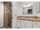 Clean bathroom featuring a tiled shower, vanity, neutral tiling, and updated fixtures at 1650 E Gary St, Mesa, AZ 85203