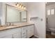 Bathroom featuring a granite-topped vanity and decorative mirror at 1650 E Gary St, Mesa, AZ 85203