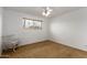 Bright bedroom with a chair and a window providing natural light at 1650 E Gary St, Mesa, AZ 85203
