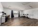Large bonus room with desk, chair, workout equipment and abundant natural light at 1650 E Gary St, Mesa, AZ 85203