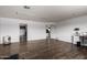 Large bonus room with dark wood flooring, and convenient access to other rooms at 1650 E Gary St, Mesa, AZ 85203