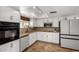 Bright kitchen boasts white cabinets, stainless steel appliances, and a corner sink with natural lighting at 1650 E Gary St, Mesa, AZ 85203