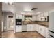 Lovely kitchen featuring white cabinets, stainless steel appliances, and backyard access at 1650 E Gary St, Mesa, AZ 85203