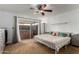 Bright main bedroom featuring a ceiling fan and access to the backyard at 1650 E Gary St, Mesa, AZ 85203