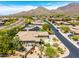 Aerial shot showcases a luxurious property with a pool, manicured landscaping, and mountain views at 16562 N 109Th Way, Scottsdale, AZ 85255