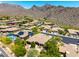 Expansive aerial view highlights the community's serene desert landscape, with majestic mountains on the horizon at 16562 N 109Th Way, Scottsdale, AZ 85255