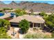 Home aerial view featuring desert landscaping, brick patio, mature shade trees and desert mountain views at 16562 N 109Th Way, Scottsdale, AZ 85255