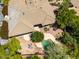 Aerial view of home showcasing tile roof, desert landscaping, patio, and pool with mature trees at 16562 N 109Th Way, Scottsdale, AZ 85255