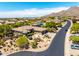 A beautiful aerial view of a desert home with lush landscaping and mountain views in the distance at 16562 N 109Th Way, Scottsdale, AZ 85255