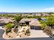 Stunning aerial view of a luxury home showcasing its desert landscaping, three-car garage and prime location at 16562 N 109Th Way, Scottsdale, AZ 85255