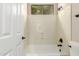 Bathroom featuring a tub and shower combination with white tiles and bronze fixtures at 16562 N 109Th Way, Scottsdale, AZ 85255