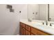 Bathroom featuring a double vanity with modern fixtures and a large mirror at 16562 N 109Th Way, Scottsdale, AZ 85255
