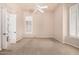 A bedroom featuring a ceiling fan, carpeted floors, and plantation shutters for natural light at 16562 N 109Th Way, Scottsdale, AZ 85255