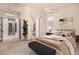 Bedroom with a queen bed, ceiling fan, ensuite bath, and carpet floors at 16562 N 109Th Way, Scottsdale, AZ 85255