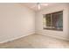 Carpeted bedroom with a bright window and beige walls at 16562 N 109Th Way, Scottsdale, AZ 85255
