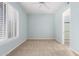 Carpeted bedroom with blue walls, ceiling fan, and bright window light at 16562 N 109Th Way, Scottsdale, AZ 85255