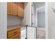 A hallway featuring cabinets, drawers, and a mini-fridge with an adjacent carpeted room at 16562 N 109Th Way, Scottsdale, AZ 85255
