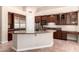 Kitchen island featuring granite countertops and storage space at 16562 N 109Th Way, Scottsdale, AZ 85255