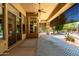 Covered patio with ceiling fan, privacy screens, desert landscaping and outdoor access at 16562 N 109Th Way, Scottsdale, AZ 85255