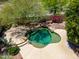 Unique pool design with rock waterfall feature and desert landscaping at 16562 N 109Th Way, Scottsdale, AZ 85255