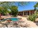 A tranquil backyard oasis features a sparkling pool surrounded by desert landscaping and outdoor living spaces at 16562 N 109Th Way, Scottsdale, AZ 85255