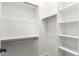 Bright, large walk-in closet featuring custom white wood shelving at 16562 N 109Th Way, Scottsdale, AZ 85255